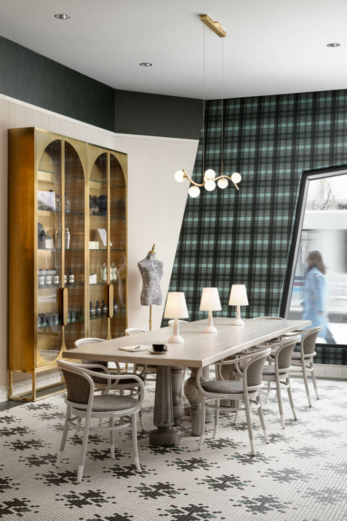 a green tartan wall and dining table are found in this hotel lobby bar