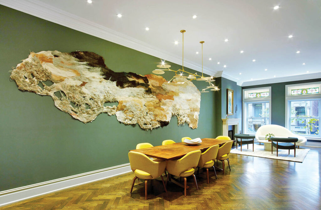Rooted, 2018, an orangically shaped textile work in the dining area of a New York residence