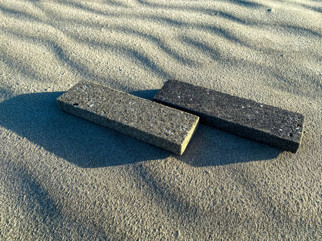 Gray long rectangular tiles in sand