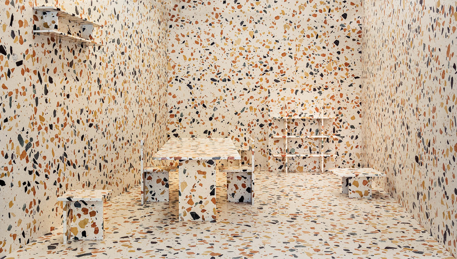 terrazzo slabs and tiles cover a room's walls and furniture