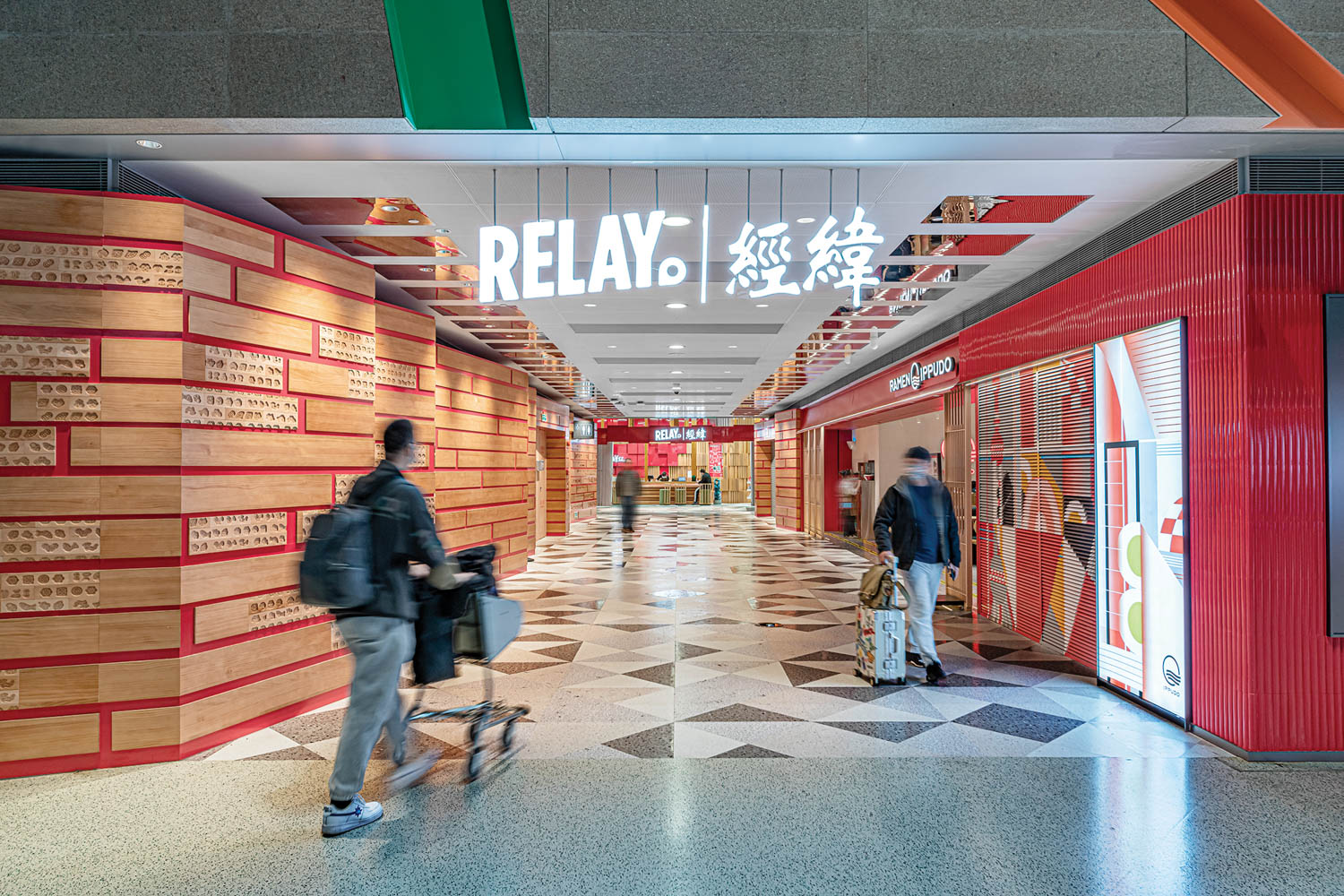 people walk through Relay, a red and pine accented bookstore in the Shanghai bookstore