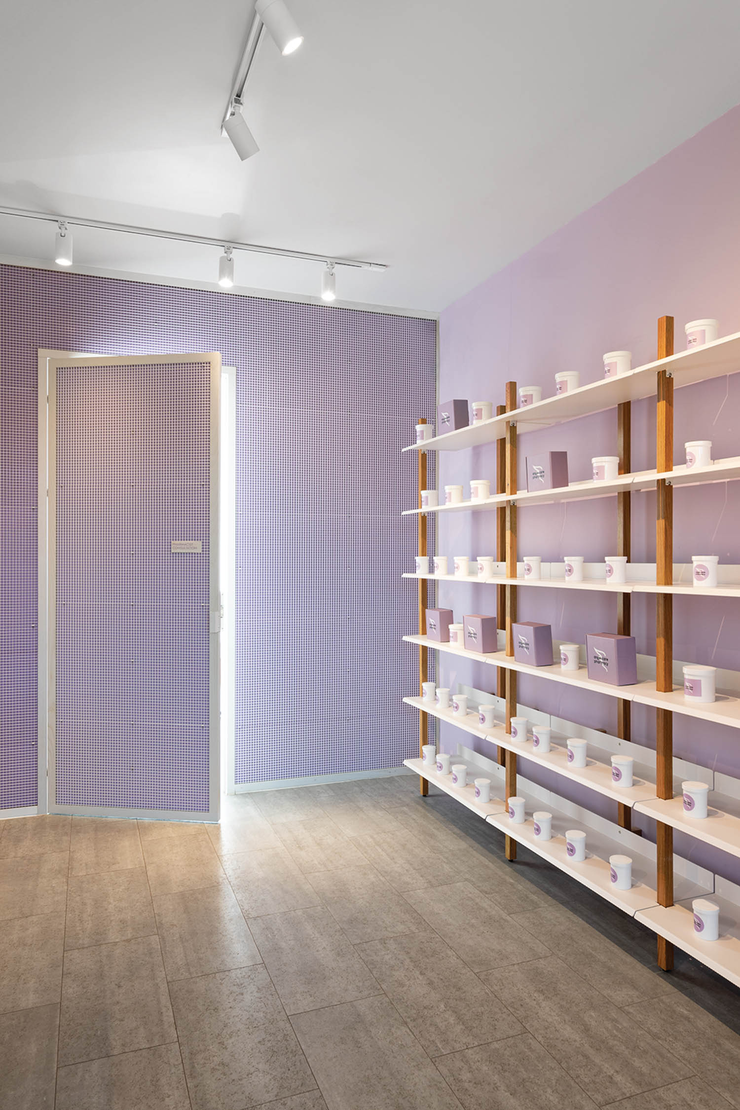 purple walls are the background behind shelving in this pharmacy
