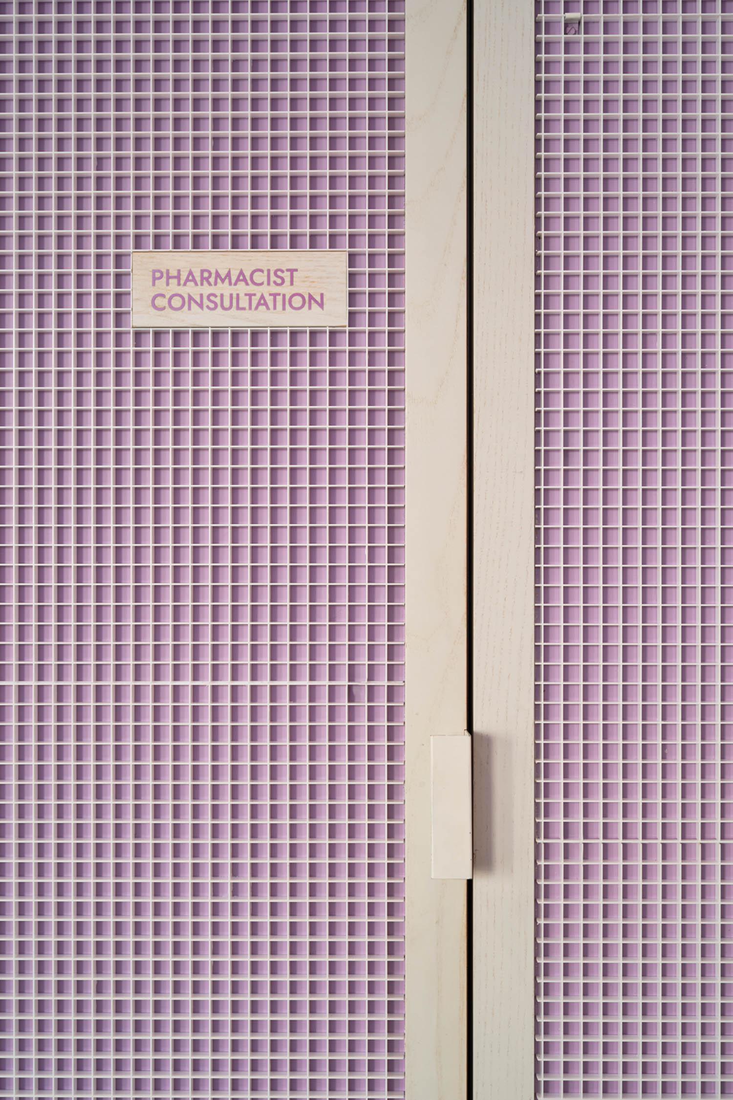 a purple waffle-print door that leads to a pharmacist consultation room