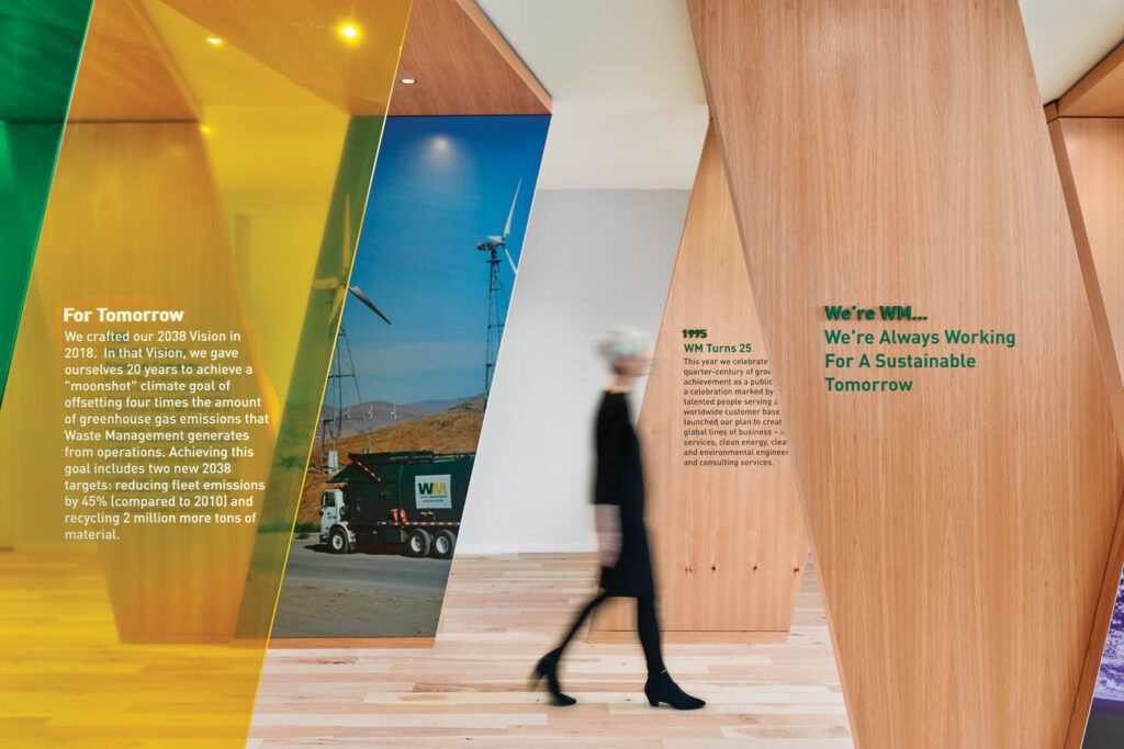A person walks through the halls of Waste Management designed by Perkins&Will