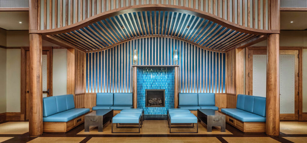 blue seating and a blue tiled fireplace under a curved ceiling