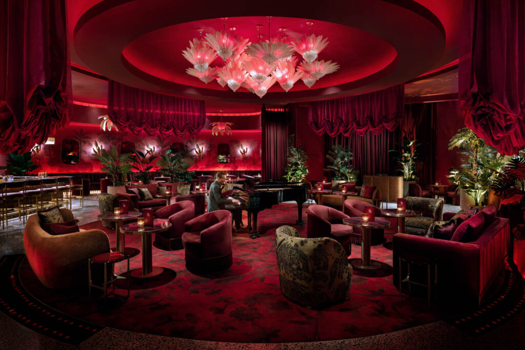 The dining room in the Rouge Room includes a chandelier and a piano