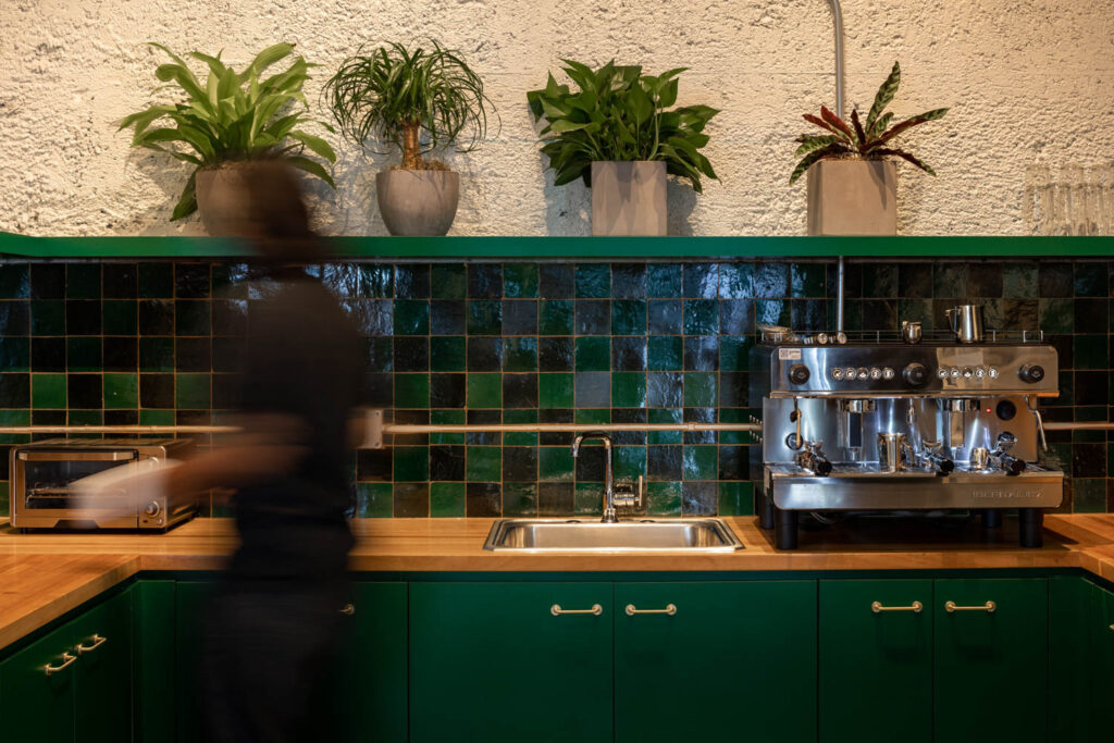a kitchenette in shades of dark green