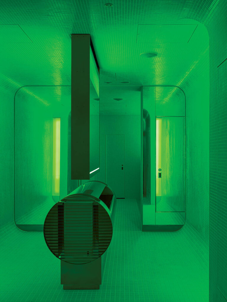 a green futuristic-looking public toilet in Japan
